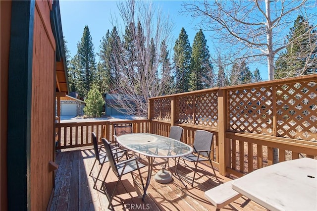 wooden terrace featuring outdoor dining space