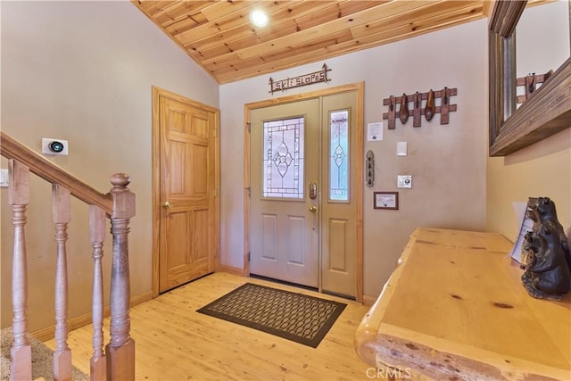 entryway with light wood-style flooring, wood ceiling, baseboards, vaulted ceiling, and stairs