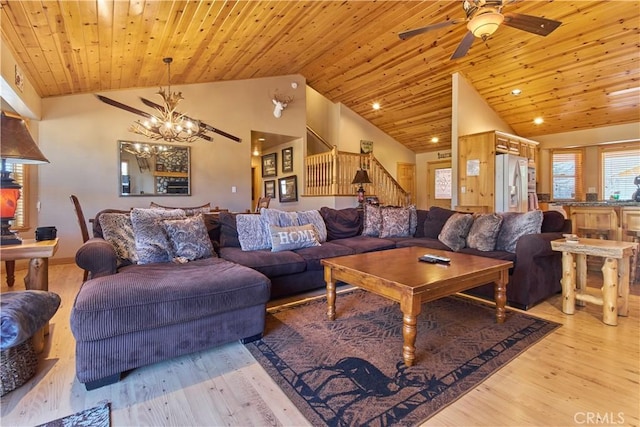 living room with stairs, light wood-style floors, wood ceiling, high vaulted ceiling, and ceiling fan with notable chandelier