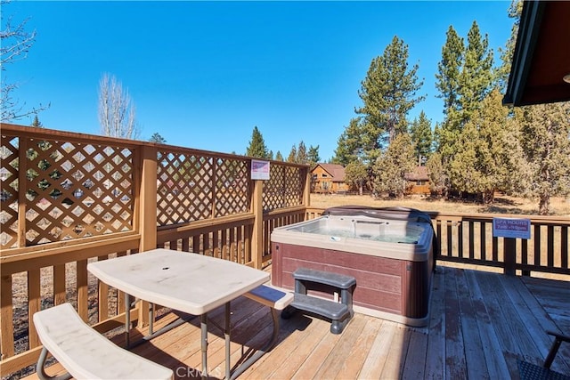 wooden deck featuring a hot tub