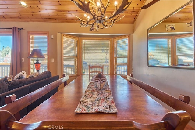 dining room featuring vaulted ceiling, wooden ceiling, and an inviting chandelier