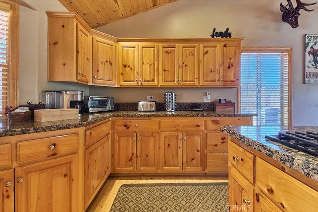 kitchen with a toaster, lofted ceiling, dark stone counters, light wood-type flooring, and wooden ceiling