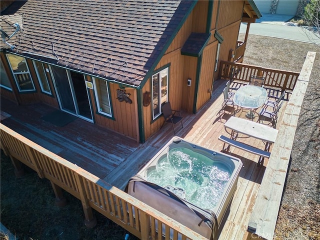 wooden terrace with outdoor dining space and hot tub deck surround