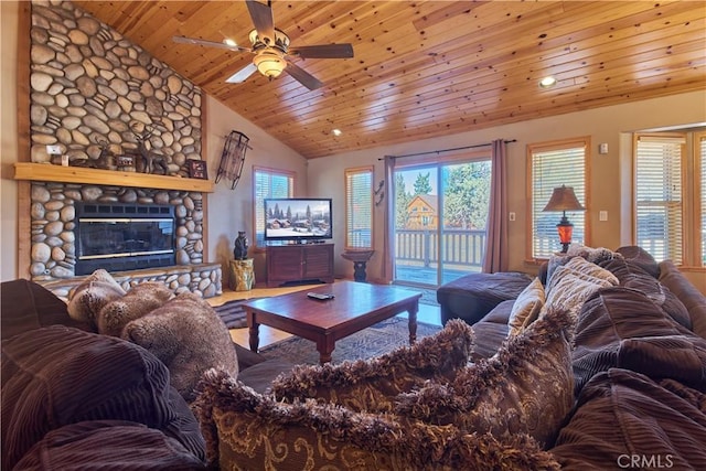 living room featuring lofted ceiling, a stone fireplace, wood ceiling, and a healthy amount of sunlight