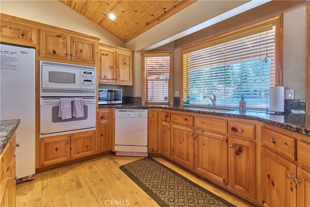 kitchen with wooden ceiling, white appliances, a sink, light wood-style floors, and vaulted ceiling