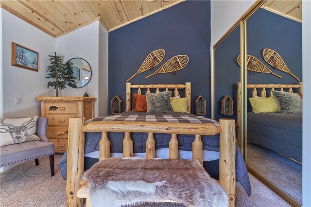 carpeted bedroom with a closet, lofted ceiling, and wood ceiling