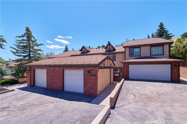 view of front of property featuring a garage and brick siding