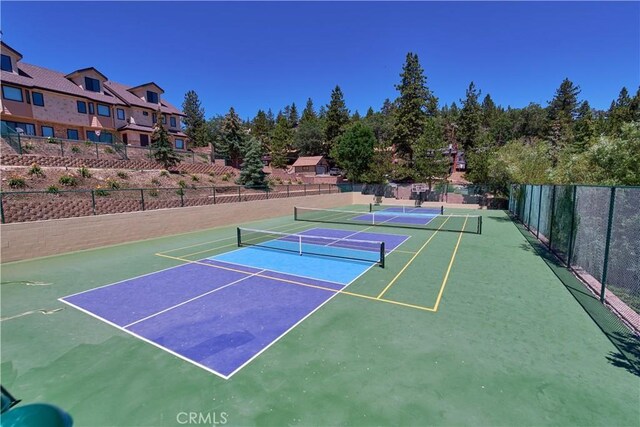 view of sport court with fence