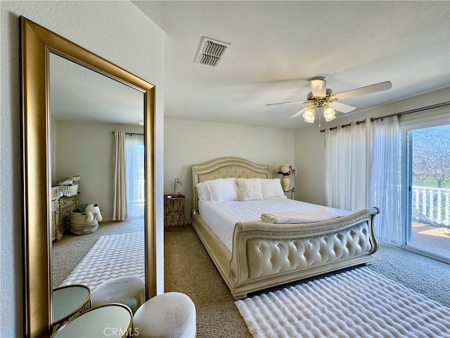 bedroom with a ceiling fan, visible vents, carpet floors, access to exterior, and a textured ceiling