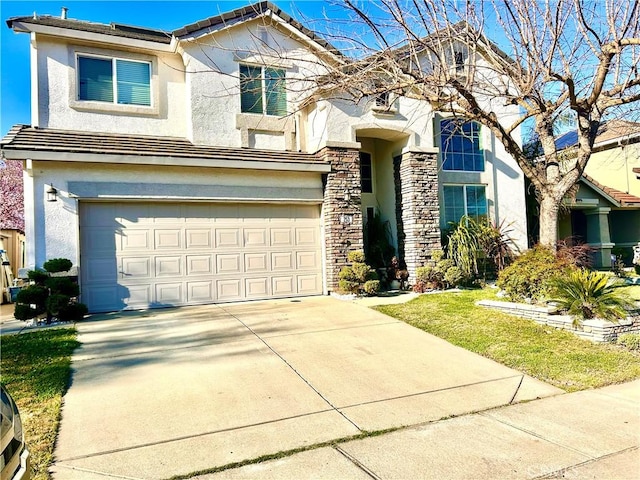 view of front of house featuring a garage, concrete driveway, stone siding, a tiled roof, and stucco siding