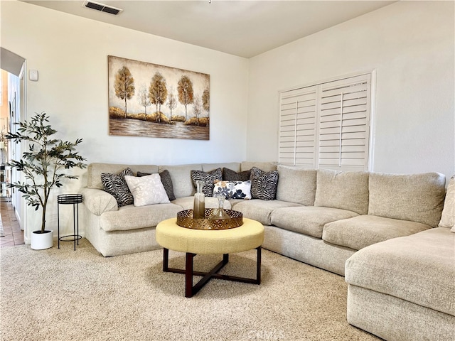 carpeted living area featuring visible vents
