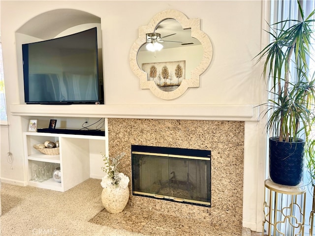 details with carpet, a fireplace, and ceiling fan