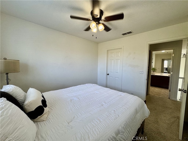 carpeted bedroom with visible vents and a ceiling fan