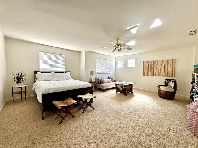 carpeted bedroom featuring visible vents, ceiling fan, and baseboards