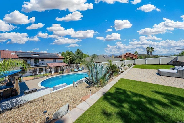 view of swimming pool with a patio area, a fenced backyard, a fenced in pool, and a lawn