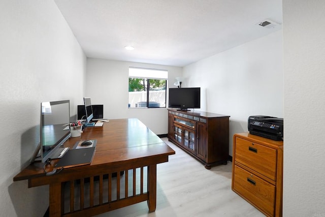 office area featuring light wood-type flooring and visible vents