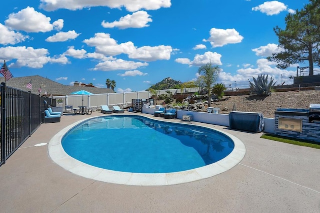 view of swimming pool with a patio, fence, and a fenced in pool