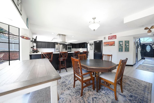 dining area featuring light wood-style floors