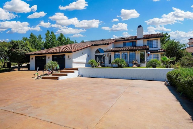 23767 Moonglow Ct, Ramona, CA 92065 - view of front facade featuring an attached garage, a tile roof, a chimney, and stucco siding
