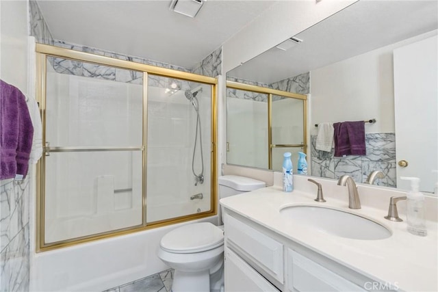 full bathroom with marble finish floor, enclosed tub / shower combo, vanity, and toilet