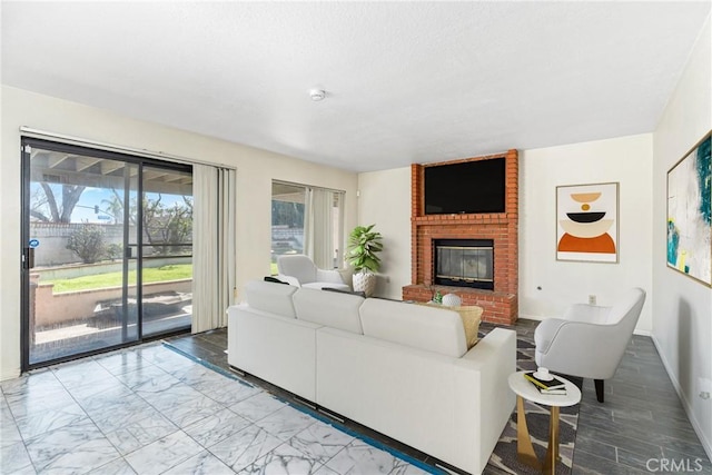 living area with marble finish floor, a fireplace, and baseboards