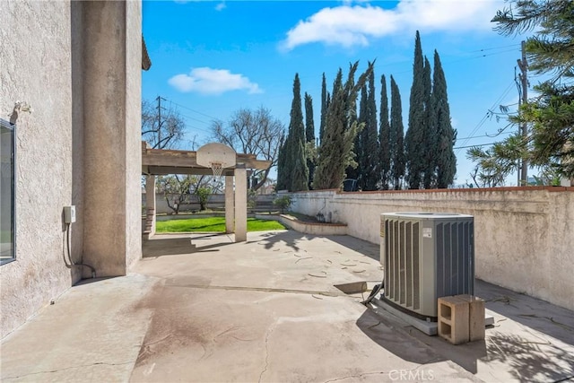 view of patio with central AC and fence