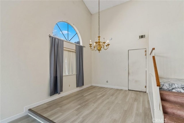 dining room with baseboards, an inviting chandelier, visible vents, and light wood-style floors