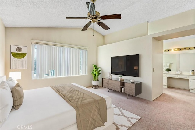 bedroom with lofted ceiling, light colored carpet, ceiling fan, and a textured ceiling