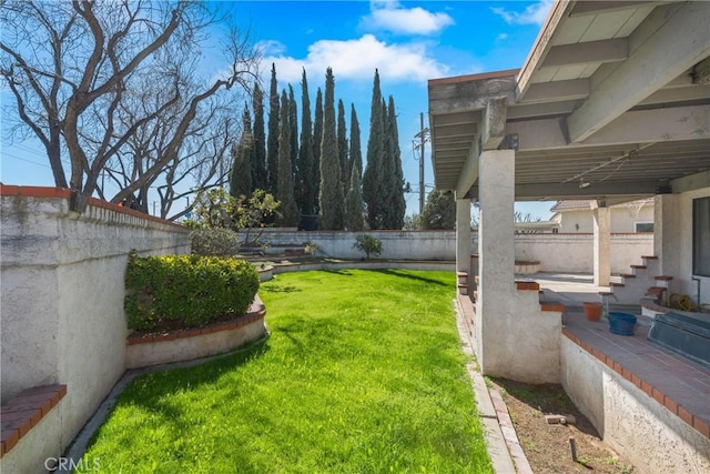 view of yard featuring a patio area and a fenced backyard