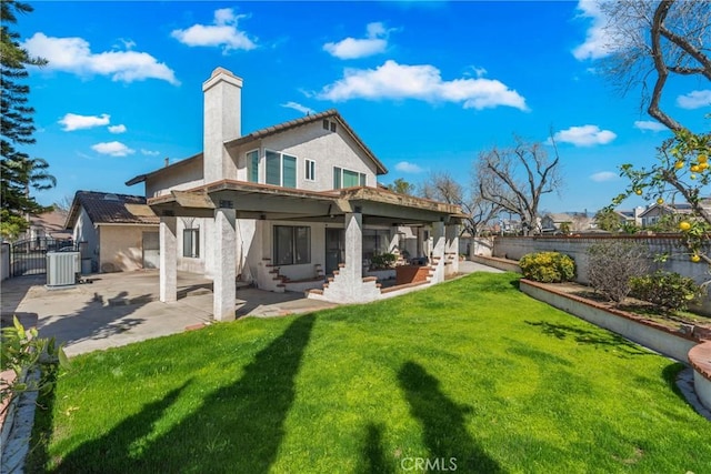 back of house featuring central AC, a gate, a patio area, and a fenced backyard