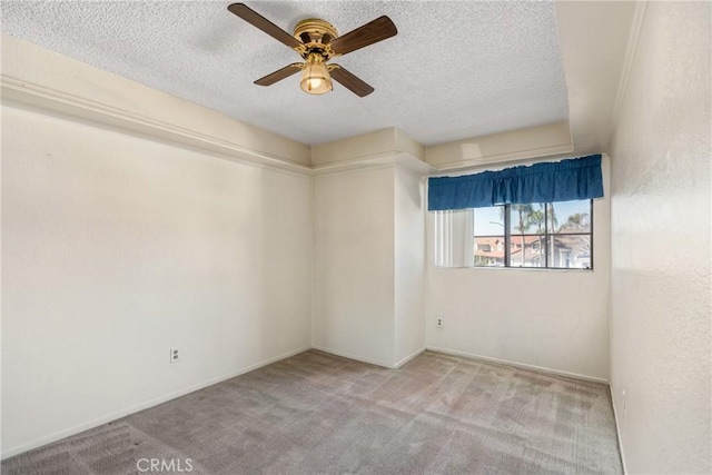 unfurnished room featuring a ceiling fan, carpet flooring, and a textured ceiling