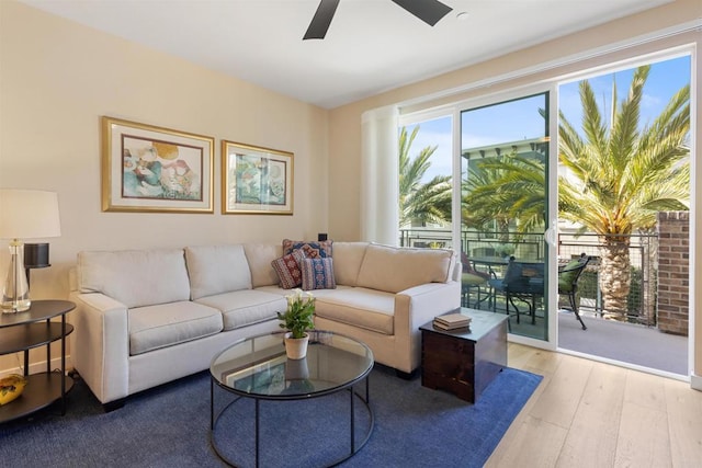 living area with ceiling fan and light wood-style flooring