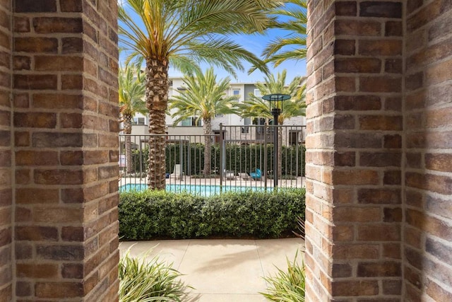 view of swimming pool with fence