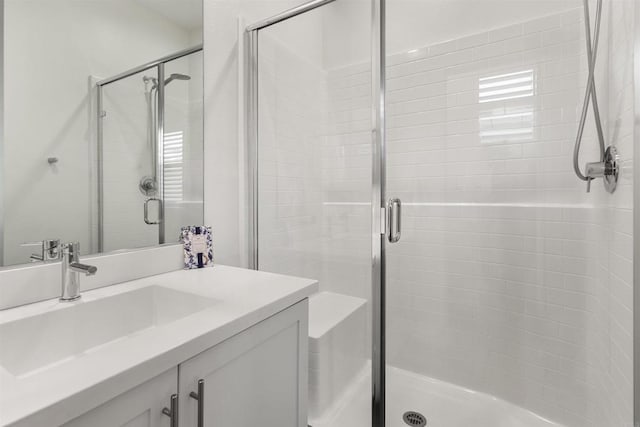 bathroom with vanity and a stall shower