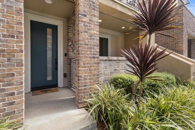 property entrance featuring brick siding