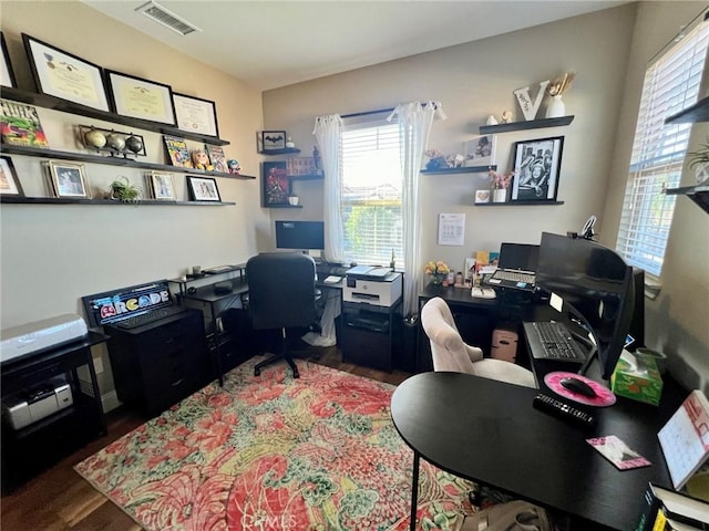 office area featuring visible vents and wood finished floors