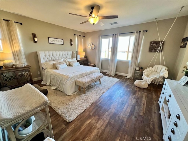 bedroom featuring ceiling fan, visible vents, dark wood finished floors, and baseboards