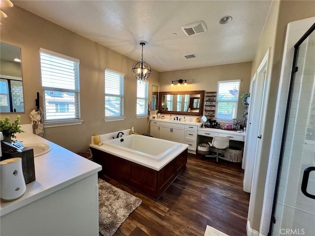 32526 Presidio Hills Ln, Winchester, CA 92596 - full bathroom featuring wood finished floors, a garden tub, two vanities, and a stall shower
