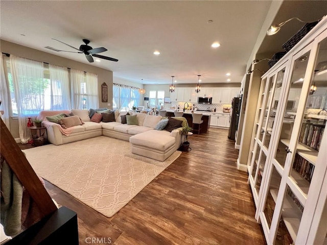 living room with dark wood-type flooring, recessed lighting, and ceiling fan