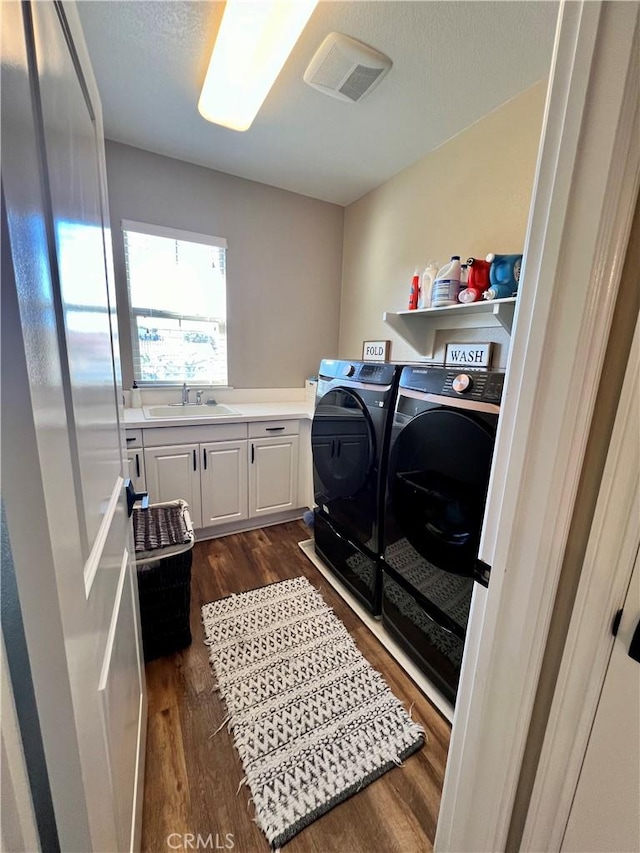 32526 Presidio Hills Ln, Winchester, CA 92596 - washroom with washing machine and clothes dryer, dark wood finished floors, and cabinet space