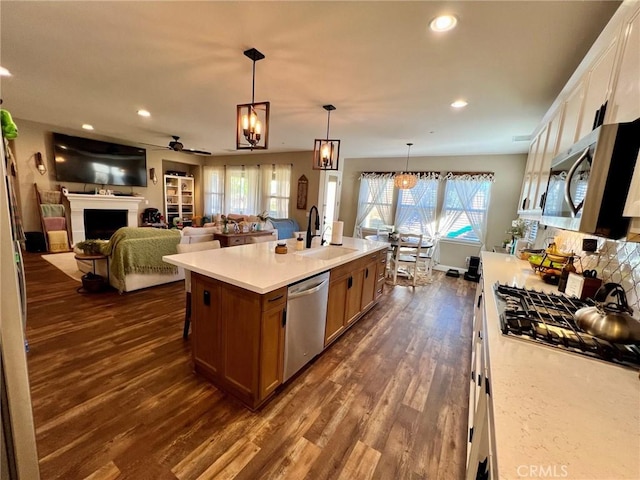 32526 Presidio Hills Ln, Winchester, CA 92596 - kitchen with a sink, stainless steel appliances, a ceiling fan, dark wood-style flooring, and light countertops