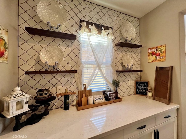 kitchen with light stone countertops, white cabinets, and open shelves