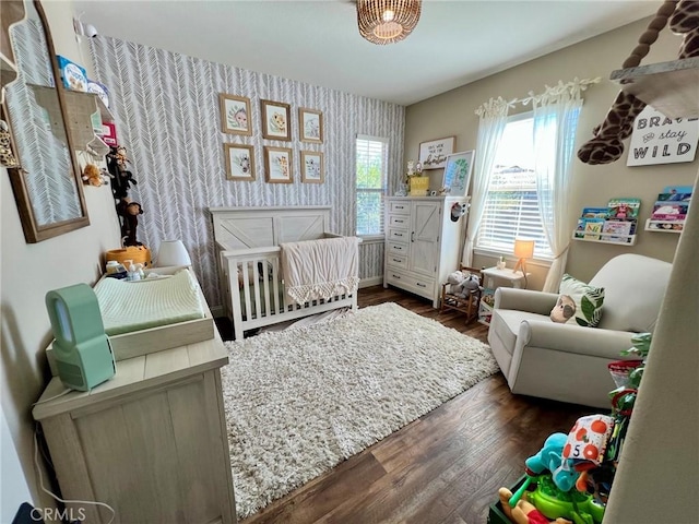32526 Presidio Hills Ln, Winchester, CA 92596 - bedroom with wallpapered walls, wood finished floors, and a nursery area