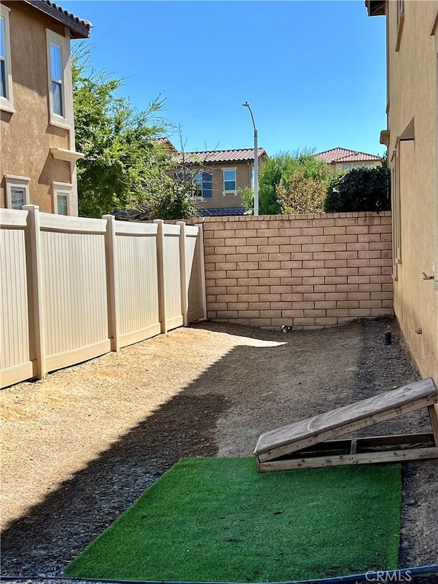 view of yard with a fenced backyard