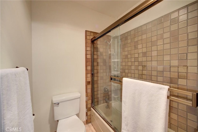 full bathroom featuring enclosed tub / shower combo and toilet