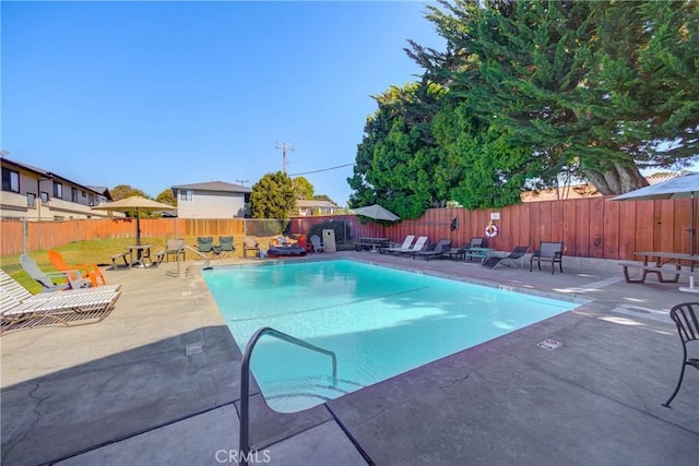 pool with a fenced backyard and a patio