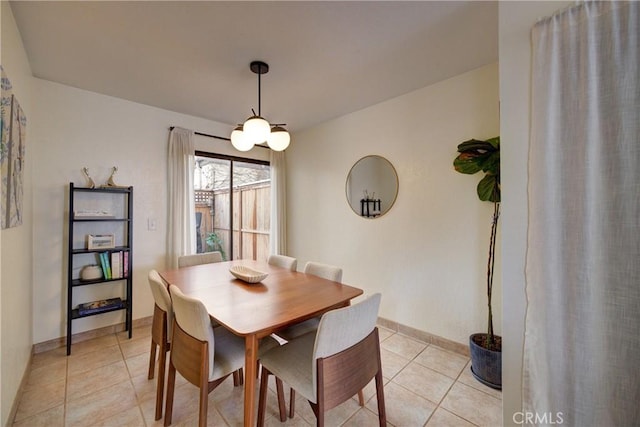 dining area featuring baseboards and light tile patterned floors