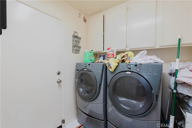 washroom with cabinet space and separate washer and dryer