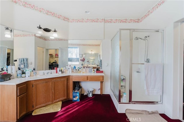 bathroom with a shower stall and vanity