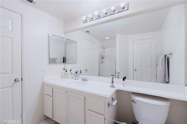 full bath with visible vents, a stall shower, vanity, and toilet